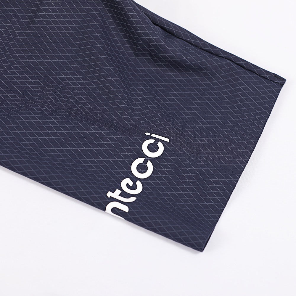 Montecci logo on a navy blue textured fabric background