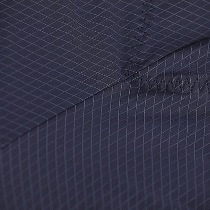 Close-up of a navy blue fabric with a subtle pattern and stitching detail.